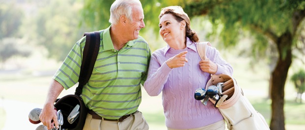 Older couple playing golf