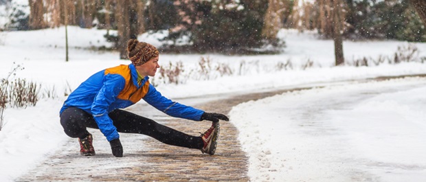 Woman stretching in the snow.