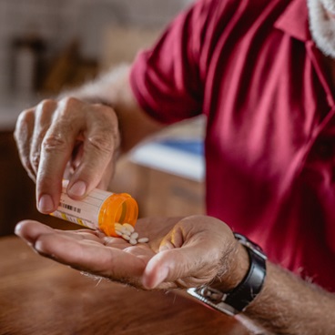 man holding pillsman holding pills