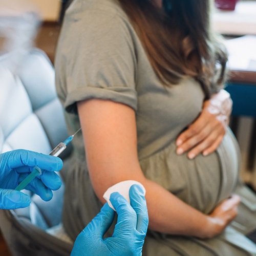 Pregnant woman getting a COVID-19 vaccination.