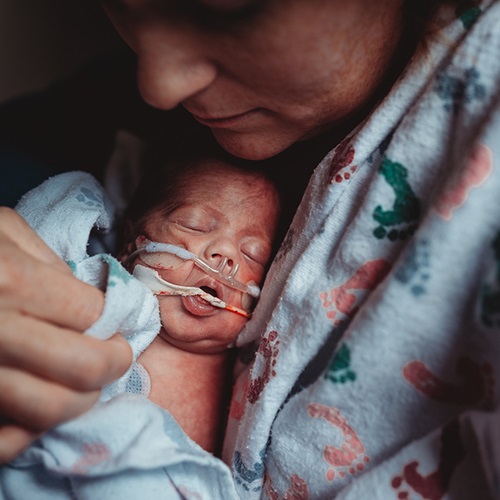 Mother caring for her NICU infant.