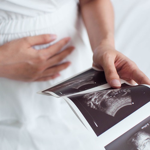 woman looking at ultrasound pictures