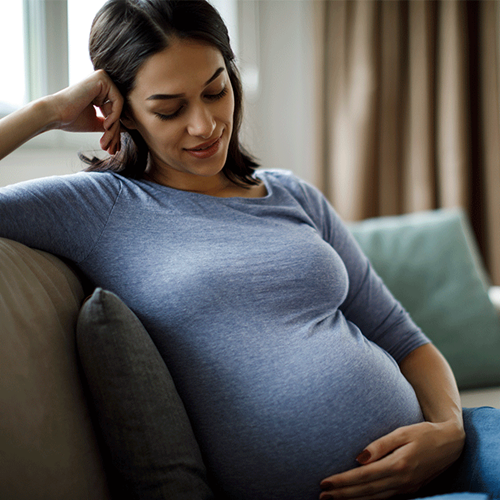 pregnant woman rubbing her belly tenderly