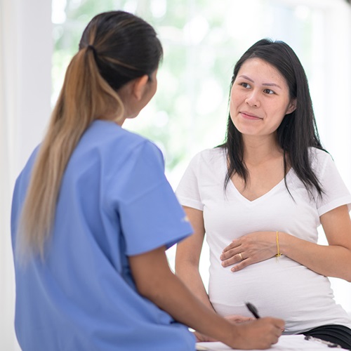 Pregnant mother talking to her provider.