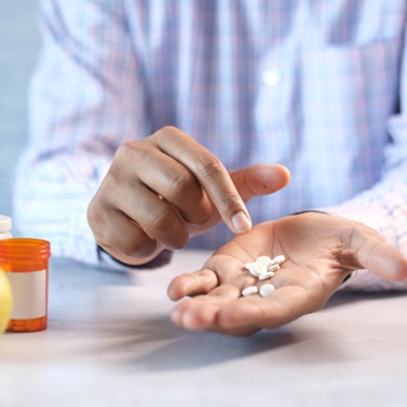 Person with handful of medication